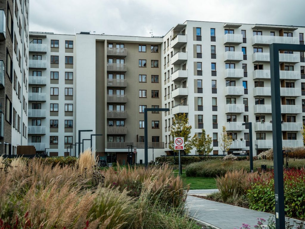 High-rise residential buildings with landscaped area in an urban setting.